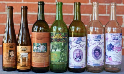 A row of Marjim Manor wine bottles with personalized labels