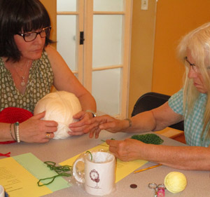 lisa helping student crochet